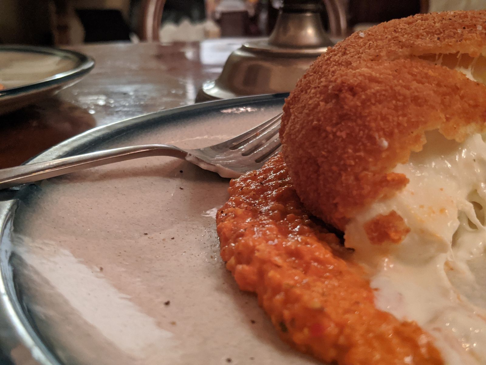 Fried breaded burrata on a romesco-style sauce